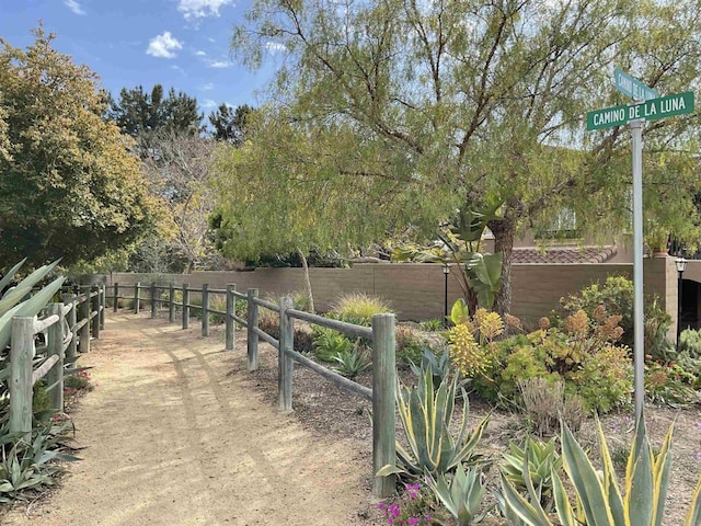 view of home's community with fence