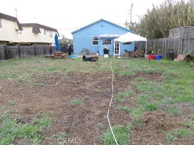 back of property featuring a fenced backyard