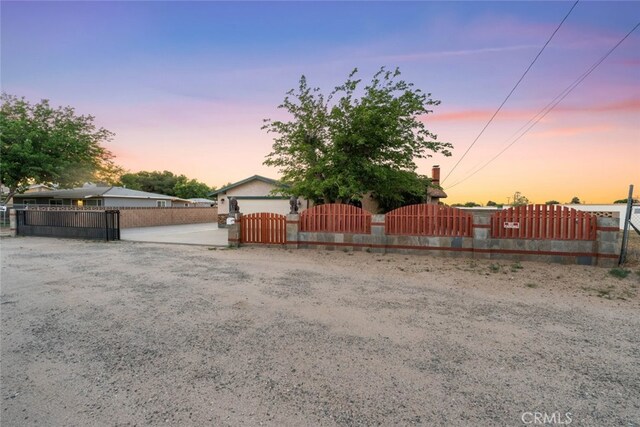 5111 W W Ave M2, Lancaster, CA 93536 - yard at dusk featuring a gate and a fenced front yard