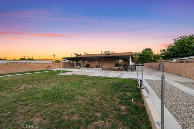 5111 W W Ave M2, Lancaster, CA 93536 - back of house at dusk with a patio