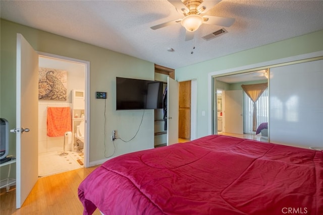 5111 W W Ave M2, Lancaster, CA 93536 - bedroom with wood finished floors, a textured ceiling, a closet, ensuite bath, and a ceiling fan