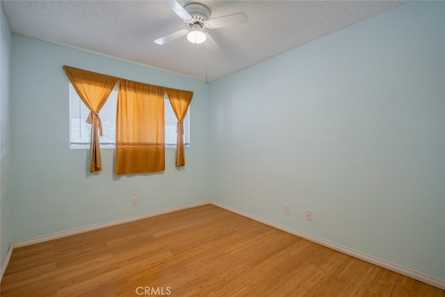 5111 W W Ave M2, Lancaster, CA 93536 - empty room with light wood-type flooring, a ceiling fan, baseboards, and a textured ceiling