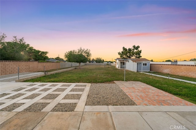 5111 W W Ave M2, Lancaster, CA 93536 - yard at dusk with an outbuilding and a patio