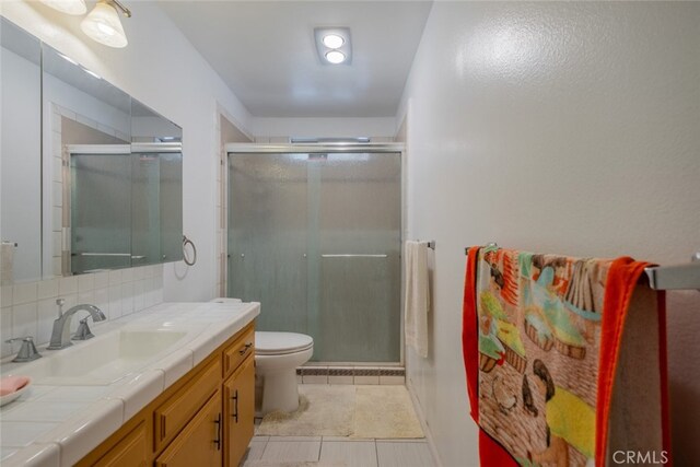 5111 W W Ave M2, Lancaster, CA 93536 - full bathroom with a shower stall, toilet, tile patterned flooring, vanity, and tasteful backsplash
