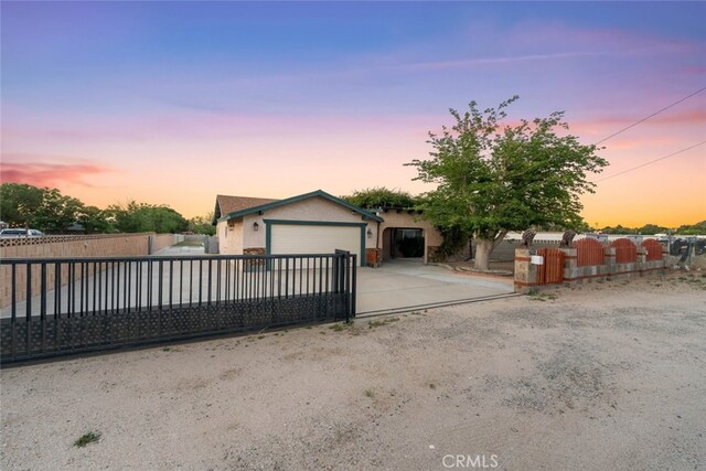 5111 W W Ave M2, Lancaster, CA 93536 - ranch-style house featuring a fenced front yard, stucco siding, driveway, and a garage