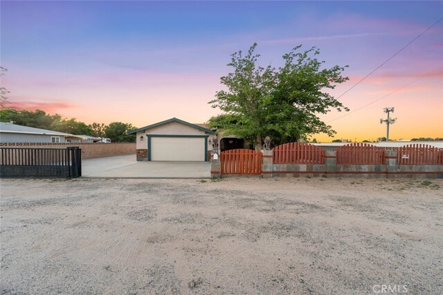 5111 W W Ave M2, Lancaster, CA 93536 - garage at dusk featuring fence, a gate, and concrete driveway