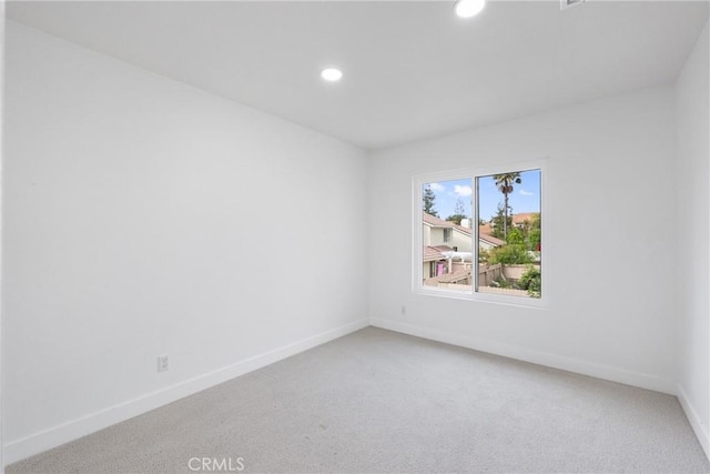 unfurnished room with light carpet, baseboards, and recessed lighting