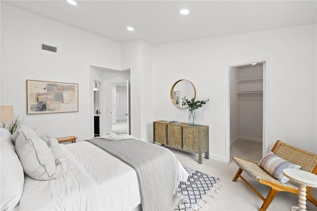 carpeted bedroom with baseboards, visible vents, a spacious closet, and recessed lighting