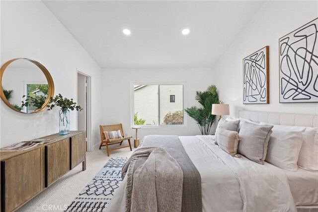 bedroom with recessed lighting, vaulted ceiling, light colored carpet, and multiple windows