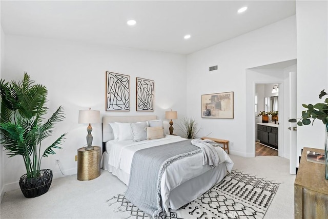 carpeted bedroom with baseboards, ensuite bathroom, visible vents, and recessed lighting