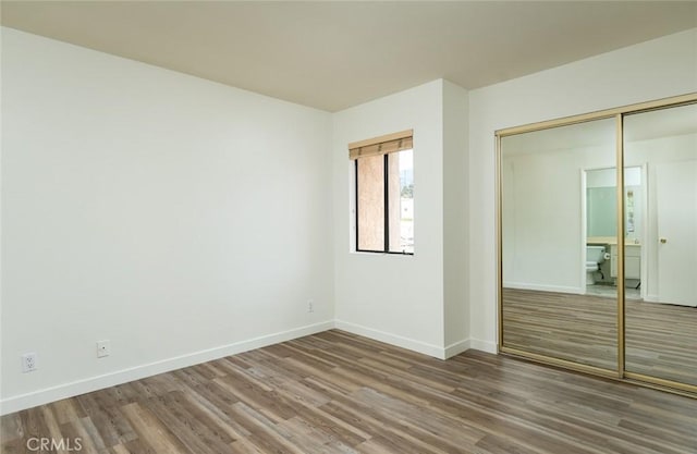 527 E Elmwood Ave Unit E, Burbank, CA 91501 - unfurnished bedroom with baseboards, wood finished floors, and a closet