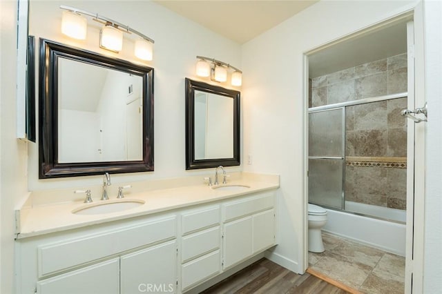 527 E Elmwood Ave Unit E, Burbank, CA 91501 - bathroom featuring double vanity, toilet, shower / bath combination with glass door, and a sink