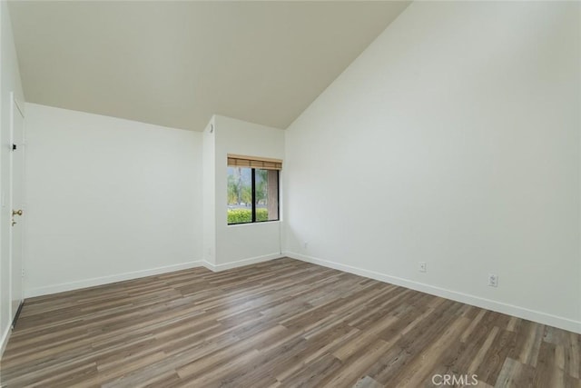 527 E Elmwood Ave Unit E, Burbank, CA 91501 - empty room featuring wood finished floors, high vaulted ceiling, and baseboards