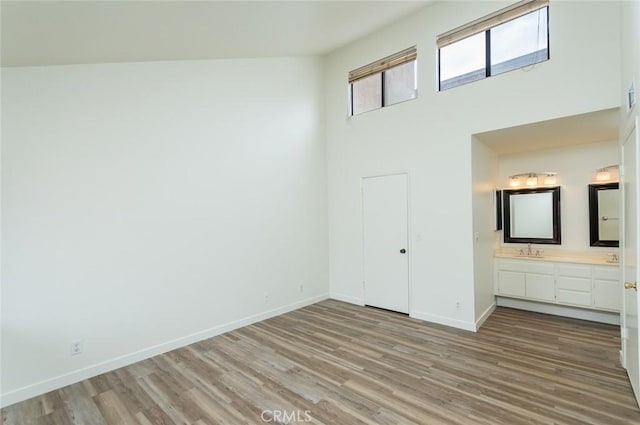 527 E Elmwood Ave Unit E, Burbank, CA 91501 - interior space featuring a towering ceiling, light wood-style floors, and baseboards