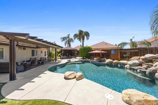 view of pool featuring a ceiling fan, a fenced in pool, a fenced backyard, a patio, and a gazebo