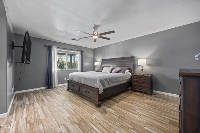 bedroom featuring baseboards, light wood-style floors, and visible vents
