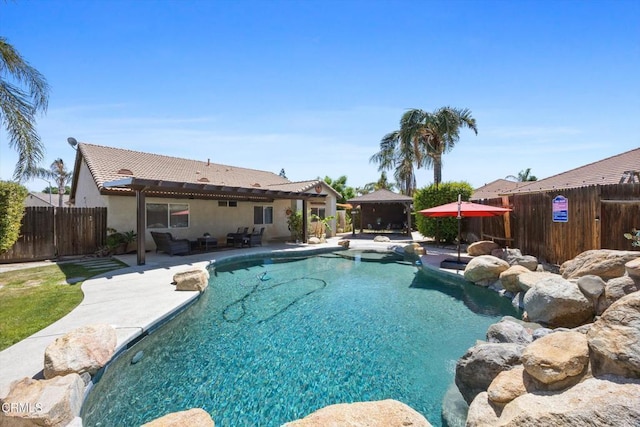 view of pool with a patio area, a fenced backyard, a fenced in pool, and a gazebo