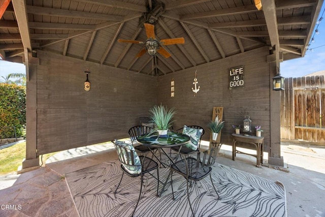 view of patio / terrace featuring fence, ceiling fan, and outdoor dining area