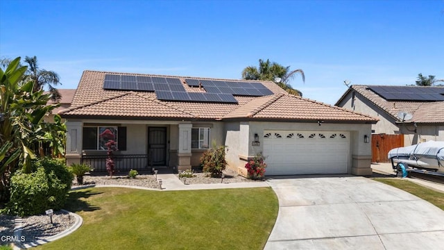 view of front of home with a front lawn, a tiled roof, driveway, a garage, and stucco siding