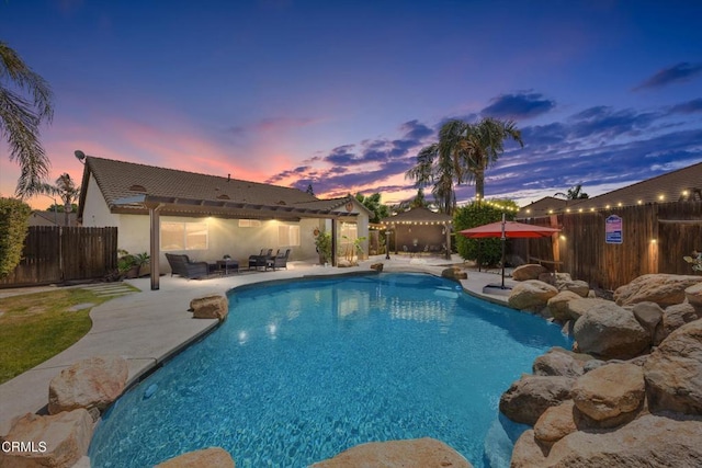 view of pool featuring a fenced in pool, a patio, a fenced backyard, and an outdoor living space