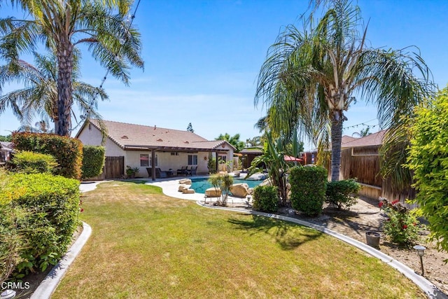 view of yard featuring an outdoor pool, a patio area, and a fenced backyard