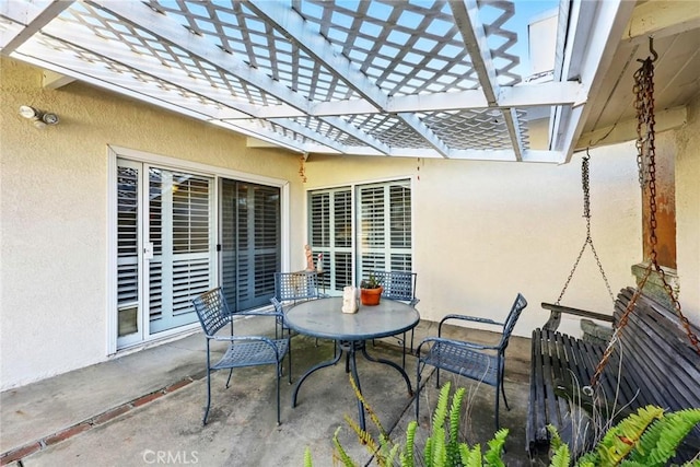 view of patio with fence and outdoor dining area