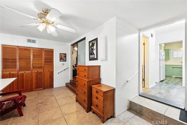 interior space with visible vents, ceiling fan, and light tile patterned floors