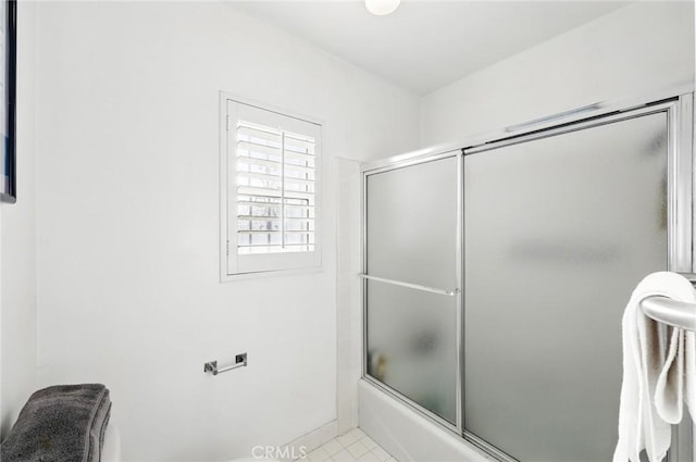 full bath featuring shower / bath combination with glass door and tile patterned floors
