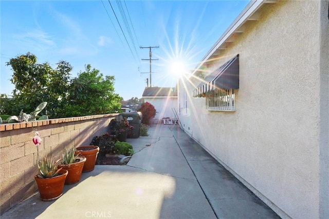 view of side of property featuring a patio and stucco siding