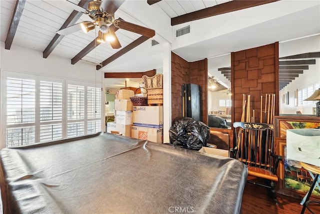 interior space featuring lofted ceiling with beams, a healthy amount of sunlight, visible vents, wood finished floors, and ceiling fan