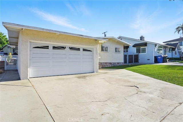 single story home with concrete driveway, a chimney, a front yard, a garage, and stucco siding