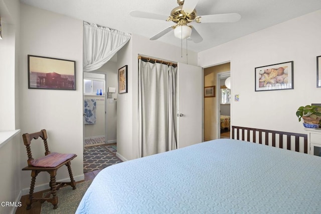 bedroom featuring a ceiling fan, baseboards, and dark carpet