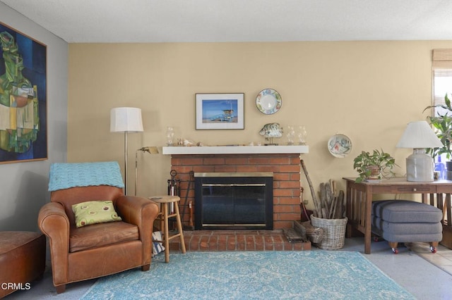 living area with a brick fireplace