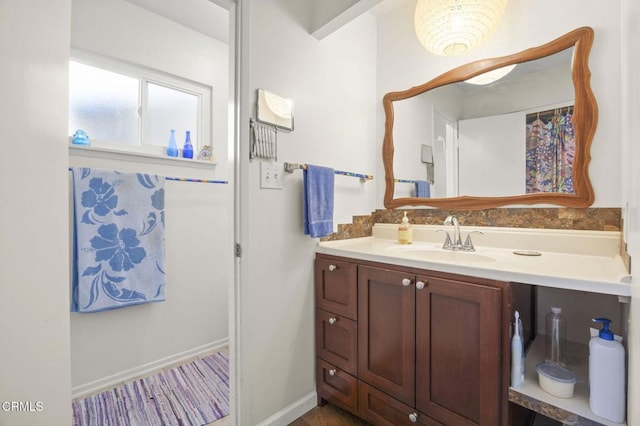 bathroom featuring baseboards and vanity
