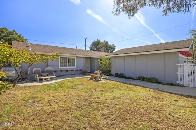 rear view of house featuring a yard, a patio area, and fence