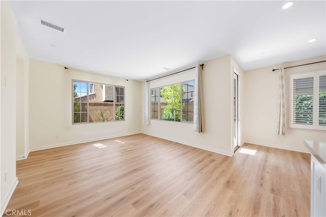 111 Messenger, Irvine, CA 92618 - empty room with plenty of natural light, visible vents, light wood finished floors, and baseboards