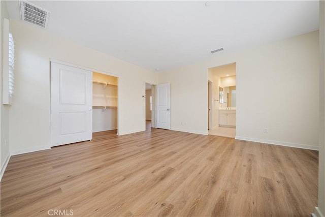 111 Messenger, Irvine, CA 92618 - unfurnished bedroom with light wood-type flooring, baseboards, visible vents, and a closet