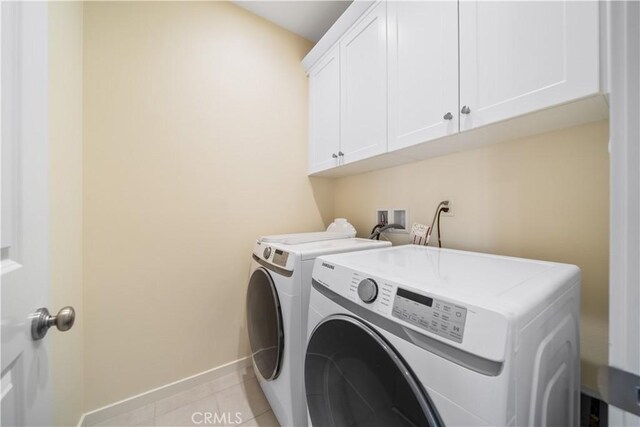 111 Messenger, Irvine, CA 92618 - laundry room featuring washing machine and dryer, baseboards, light tile patterned flooring, and cabinet space
