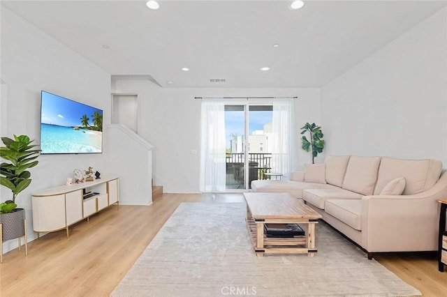 208 Novel, Irvine, CA 92618 - living room with light wood finished floors, recessed lighting, and stairway
