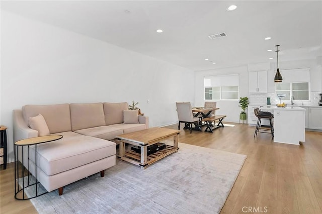 208 Novel, Irvine, CA 92618 - living room featuring recessed lighting and light wood-type flooring