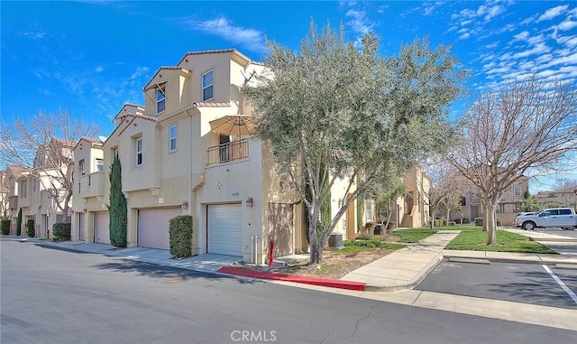 44936 Honey Locust Dr, Temecula, CA 92592 - view of building exterior with a residential view, an attached garage, and central air condition unit