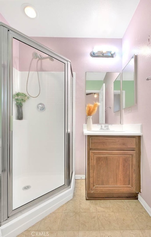 44936 Honey Locust Dr, Temecula, CA 92592 - full bathroom with vanity, tile patterned flooring, a stall shower, and baseboards