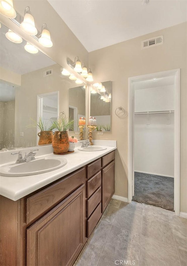 44936 Honey Locust Dr, Temecula, CA 92592 - bathroom with visible vents, a spacious closet, double vanity, and a sink