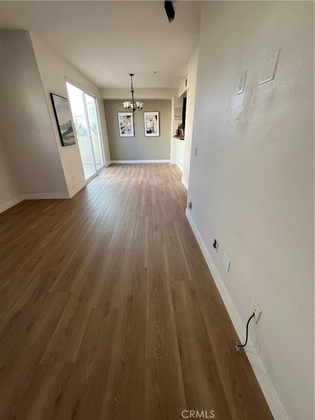 44936 Honey Locust Dr, Temecula, CA 92592 - unfurnished dining area featuring an inviting chandelier, wood finished floors, and baseboards