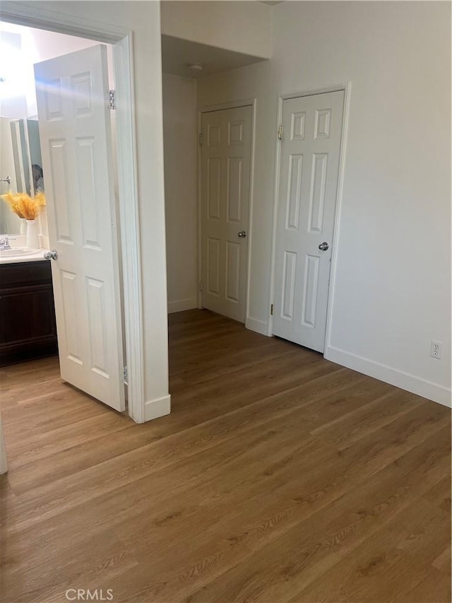 44936 Honey Locust Dr, Temecula, CA 92592 - empty room featuring a sink, light wood-style floors, and baseboards