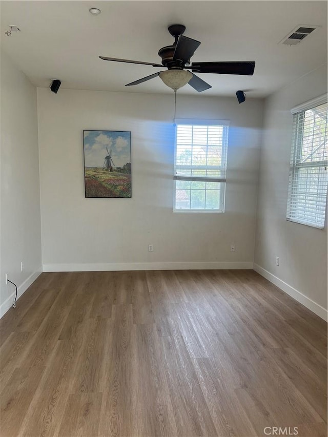 44936 Honey Locust Dr, Temecula, CA 92592 - spare room featuring wood finished floors, visible vents, a healthy amount of sunlight, and baseboards