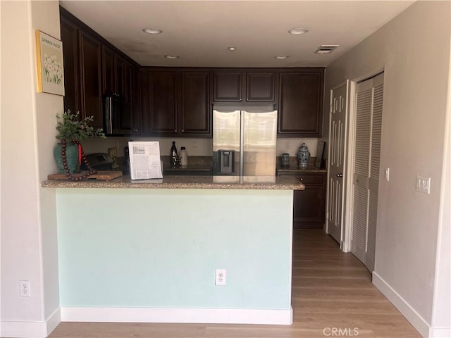 44936 Honey Locust Dr, Temecula, CA 92592 - kitchen with stainless steel fridge, visible vents, dark brown cabinetry, and a peninsula