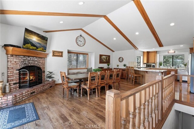 27363 Matterhorn Dr, Lake Arrowhead, CA 92352 - dining area featuring a fireplace, vaulted ceiling, light wood-type flooring, and recessed lighting