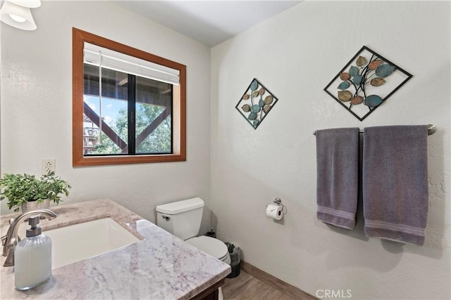 27363 Matterhorn Dr, Lake Arrowhead, CA 92352 - bathroom featuring toilet, vanity, wood finished floors, and baseboards