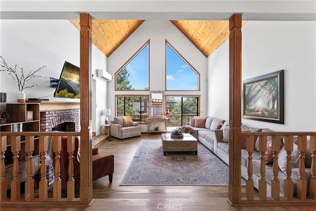 27363 Matterhorn Dr, Lake Arrowhead, CA 92352 - living room featuring a fireplace, a wall mounted air conditioner, high vaulted ceiling, and wooden ceiling